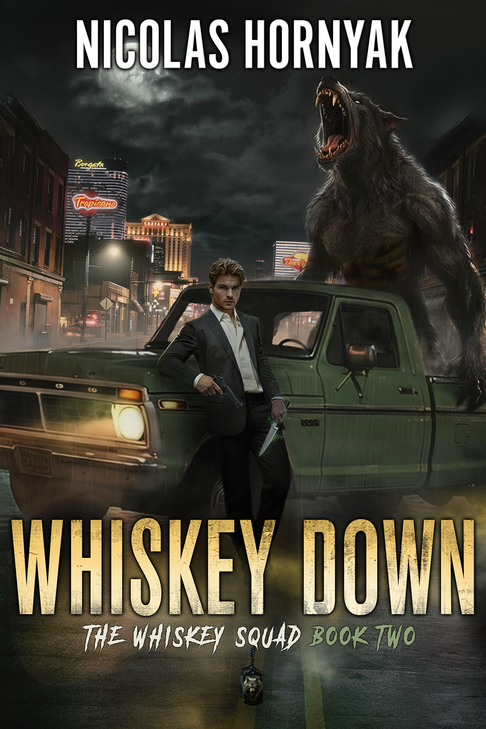 Cover of Whiskey Down: The Whiskey Squad Book Two by Nicolas Hornyak. A dark-haired man in a suit stands beside a vintage green pickup truck on a foggy city street at night, holding a knife. Behind him, an enormous snarling werewolf towers over the truck. Casino lights glow in the background, creating an urban fantasy atmosphere.